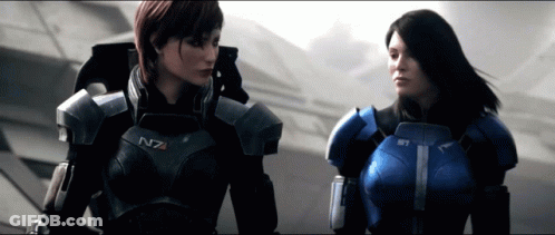 Two Women In Armor With N7 On Their Chests Stand Next To Each Other GIF