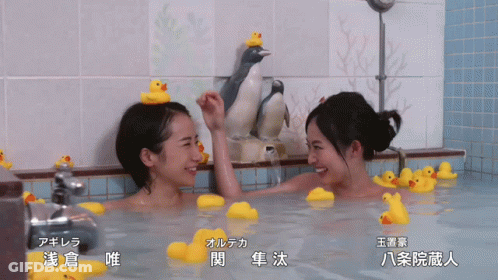 Two Women In Bathtub With Rubber Ducks On Head GIF