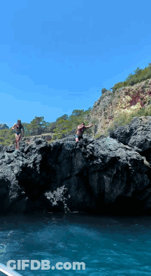 Two Women In Bikinis Jumping Into Water GIF
