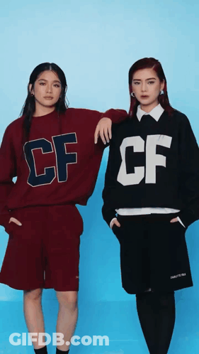 Two Women In CF Sweatshirts Standing Together GIF