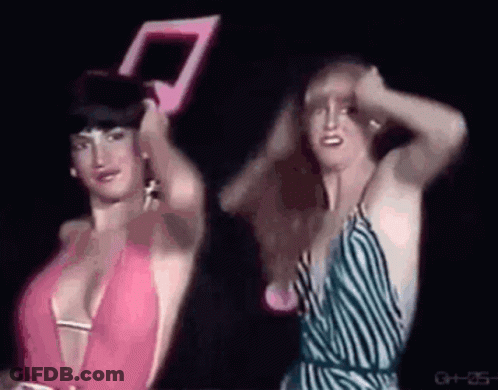 Two Women In Dark Room One Holding Mirror GIF