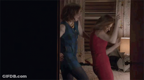 Two Women In Dresses Dancing On Bed GIF