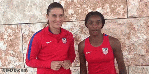 Two Women In Front Of Brick Wall GIF