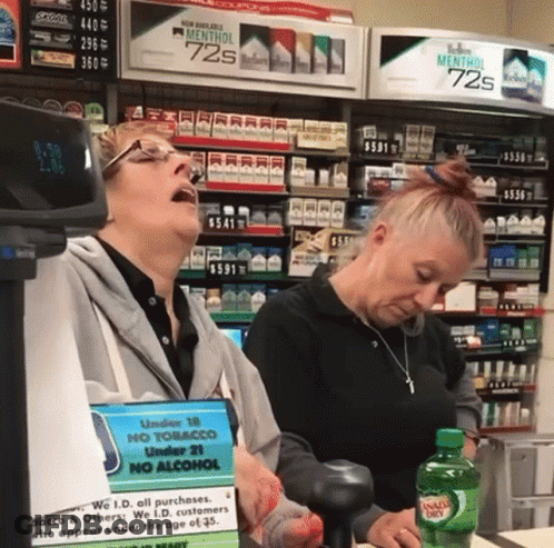 Two Women In Front Of Marlboro Display GIF