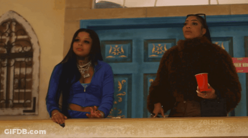 Two Women In Front Of No Smoking Sign GIF