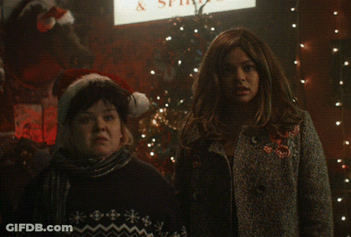 Two Women In Front Of Peachy Sign GIF