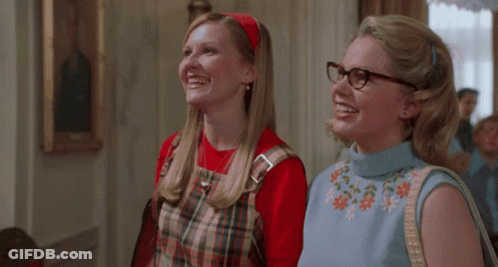 Two Women In Glasses And Plaid Dresses Smiling GIF