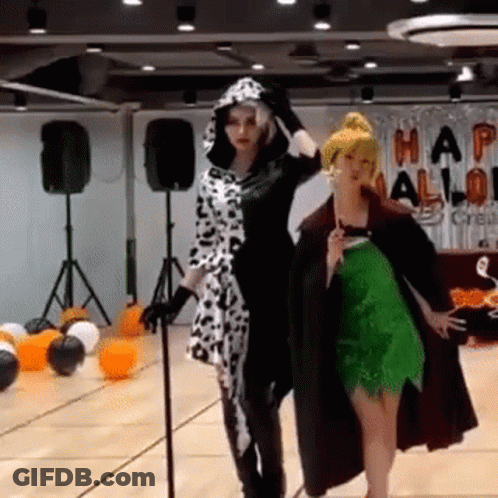 Two Women In Halloween Costumes With Balloons GIF