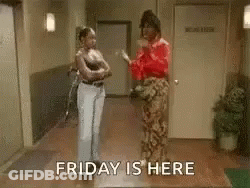 Two Women In Hallway Saying Friday Is Here GIF