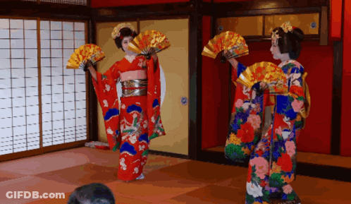 Two Women In Kimonos Dancing With Fans GIF