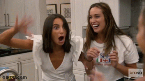 Two Women In Kitchen One Wearing Bravo Shirt GIF
