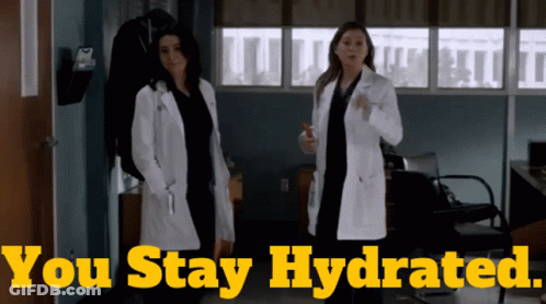 Two Women In Lab Coats Standing Next To Each Other With The Words " You Stay Hydrated " Behind Them GIF