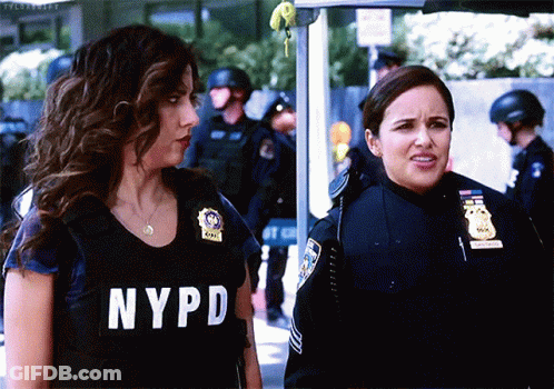 Two Women In NYPD Uniforms Standing Together GIF