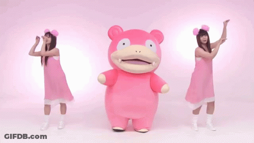 Two Women In Pink Dresses Are Dancing With A Pink Stuffed Animal In The Middle GIF