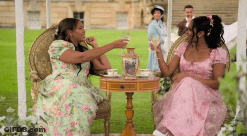 Two Women In Pink Dresses Drinking Wine GIF