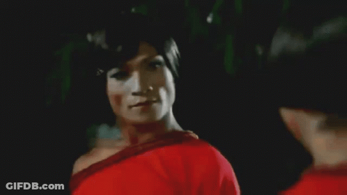 Two Women In Red Shirts Dancing In Front Of Crowd With Man In Black P Shirt GIF