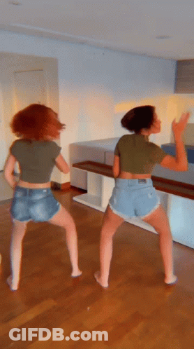 Two Women In Shorts And Crop Tops Dancing GIF