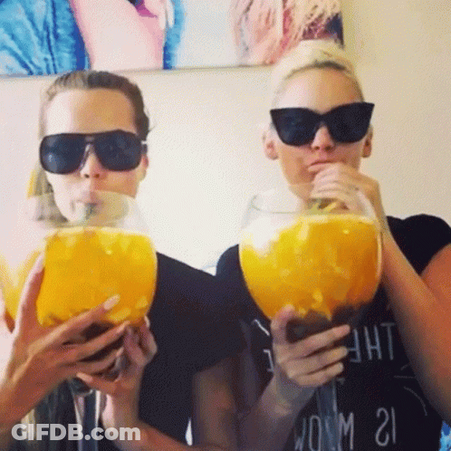 Two Women In Sunglasses Drinking From Large Glasses GIF