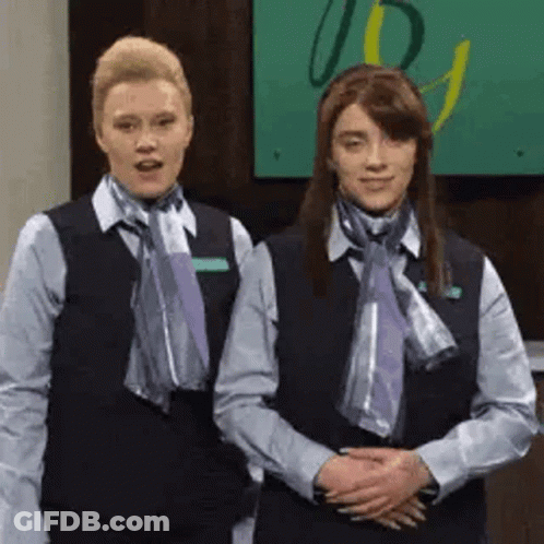 Two Women In Uniforms And Scarves In Lobby GIF