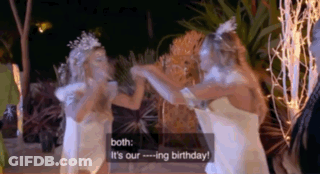 Two Women In White Dresses Are Standing Next To Each Other And Talking . GIF