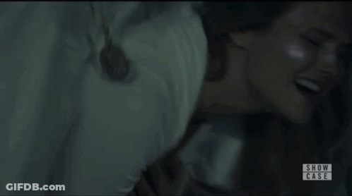 Two Women In White Dresses Dancing In Dark Room GIF