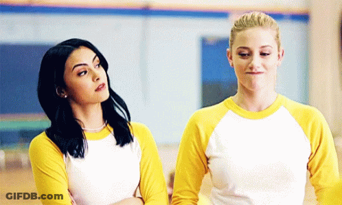 Two Women In Yellow And White Shirts Arms Crossed GIF