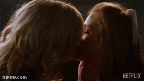Two Women Kissing In Front Of Netflix Logo GIF