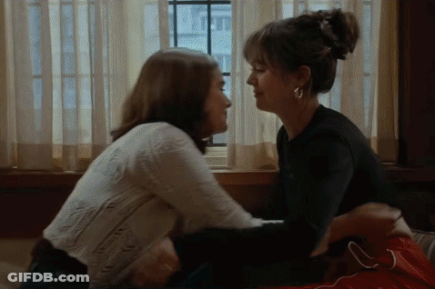 Two Women Kissing In Front Of Window GIF