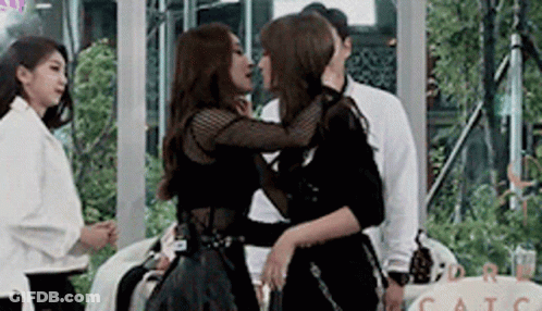 Two Women Kissing In Room GIF