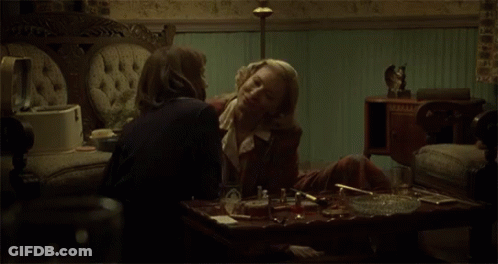 Two Women Kissing On A Couch GIF