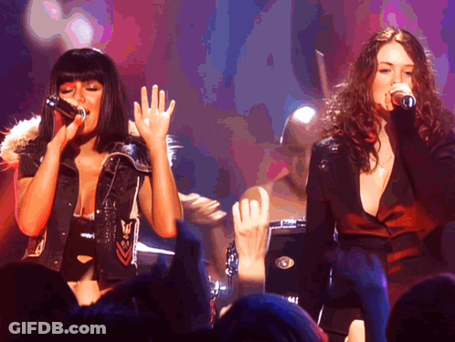 Two Women Kissing On Stage In Front Of NBC Sign GIF