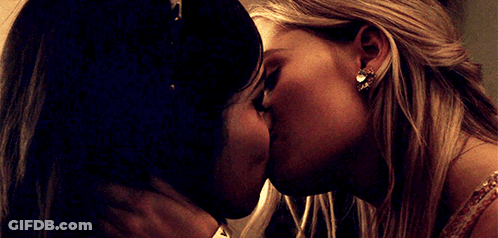 Two Women Kissing One Wearing Earrings GIF
