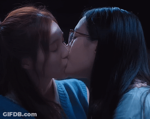 Two Women Kissing One Wearing Glasses GIF