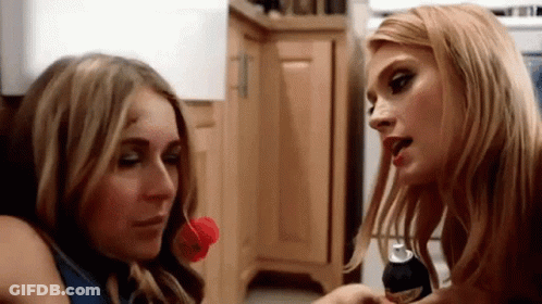 Two Women Kitchen One With Soda Can In Mouth GIF