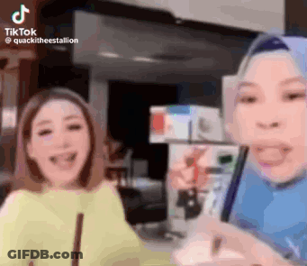 Two Women Laughing At Phone GIF