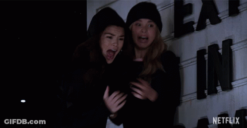 Two Women Laughing In Front Of Netflix Sign GIF