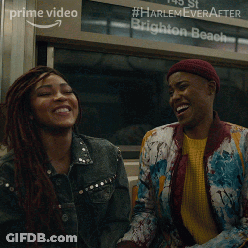Two Women Laughing In Front Of Harlem Ever After Brighton Beach Sign GIF