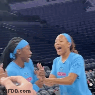 Two Women Laughing In Stadium GIF