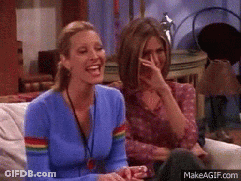 Two Women Laughing, One Covering Mouth GIF