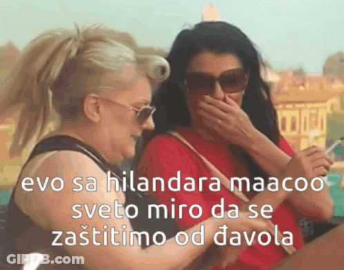 Two Women Laughing One Holding Cell Phone GIF