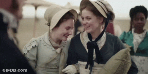 Two Women Laughing While Wearing Hats GIF