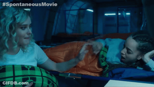 Two Women Laying In A Tent With The Words Spontaneous Movie Written On The Bottom GIF
