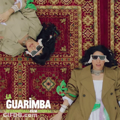 Two Women Laying On Rug Guarimba Film Festival GIF