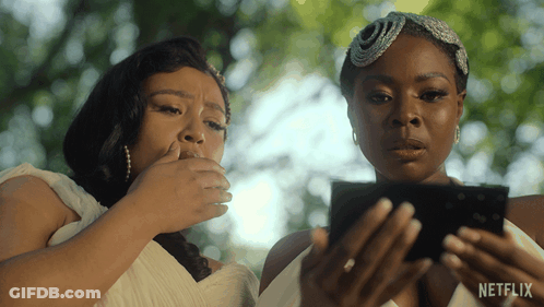 Two Women Looking At A Cell Phone With A Netflix Logo On The Bottom GIF