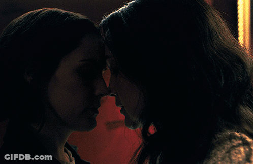 Two Women Looking At Each Other In Dark GIF