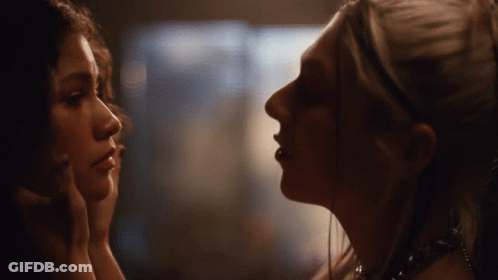 Two Women Looking At Each Other In Dark Room GIF