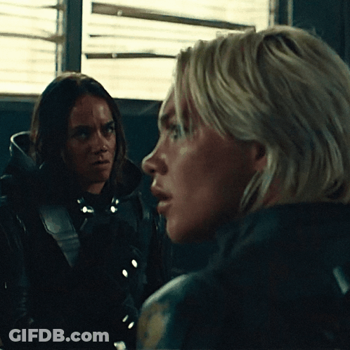 Two Women Looking At Each Other In Dark Room GIF