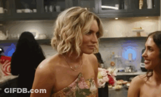 Two Women Looking At Each Other In Kitchen GIF
