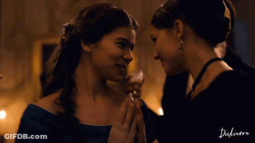 Two Women Looking At Each Other With The Word Dickinson On The Bottom Left GIF