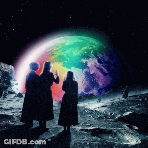Two Women Looking At Rainbow Colored Planet GIF